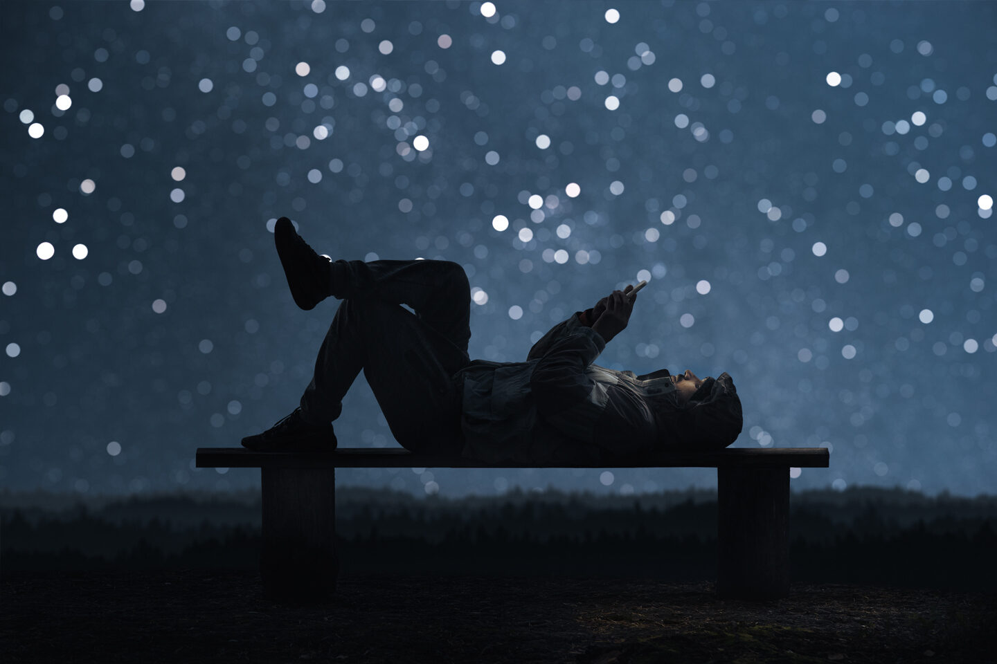 Man-with-phone-under-starlit-sky